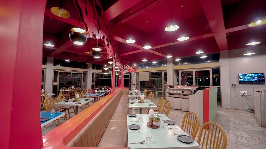 An image of a restaurant featuring chairs and tables everywhere at Pride Resort Ambaji